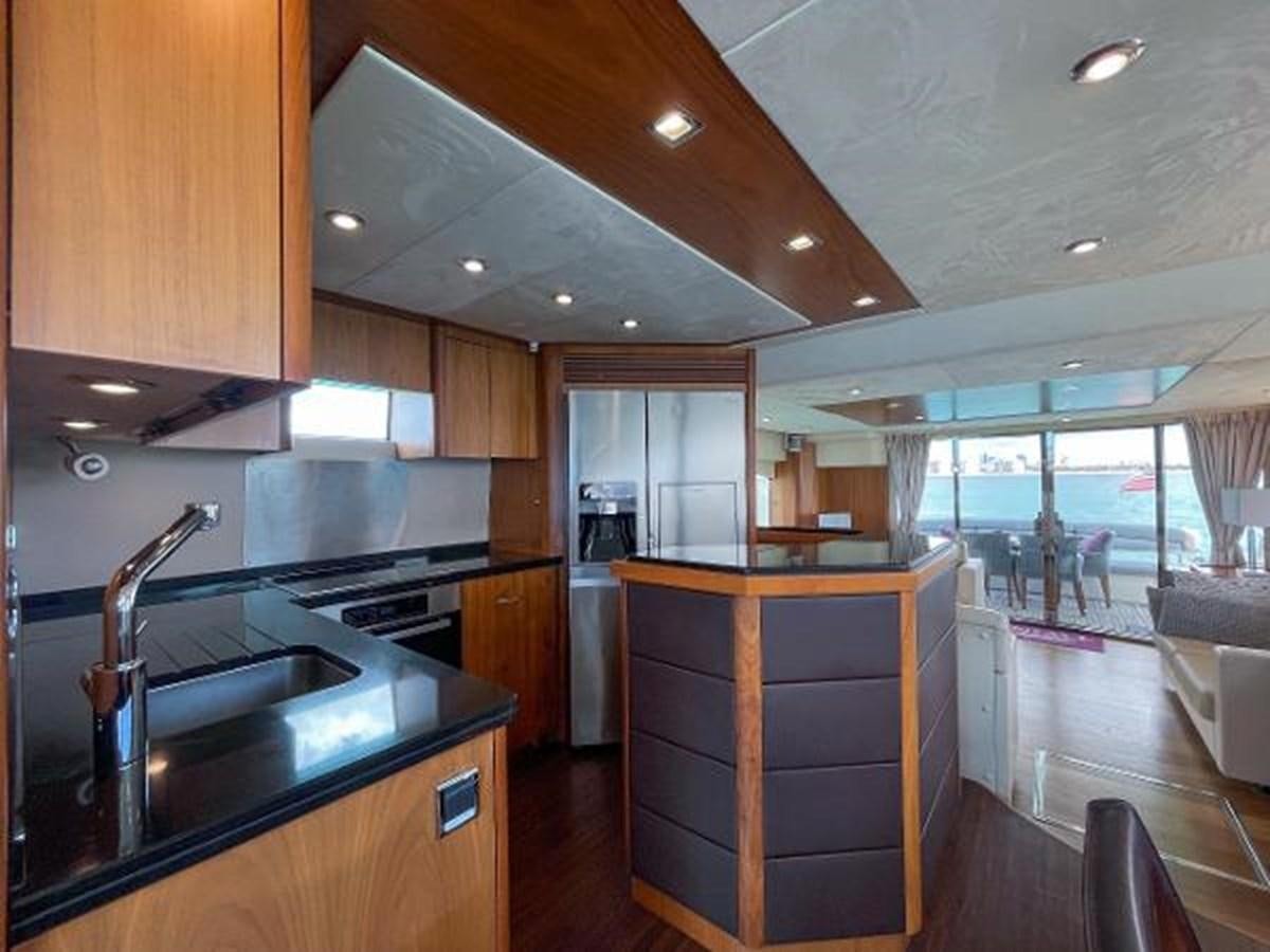 a kitchen with a large island aboard TWINS Yacht for Sale