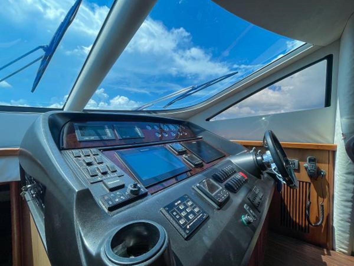 a car with a screen and a radio in the back aboard TWINS Yacht for Sale
