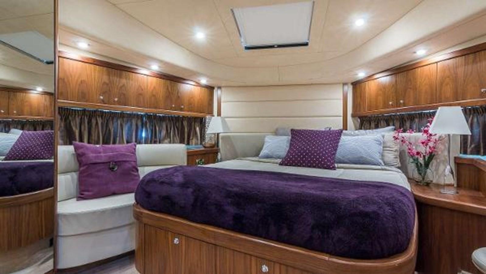 a bedroom with a bed and a desk aboard TWINS Yacht for Sale