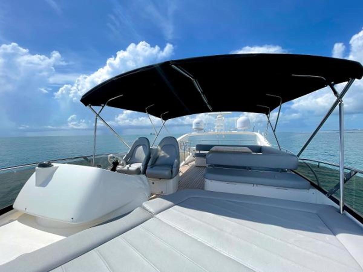 a boat with a large umbrella aboard TWINS Yacht for Sale