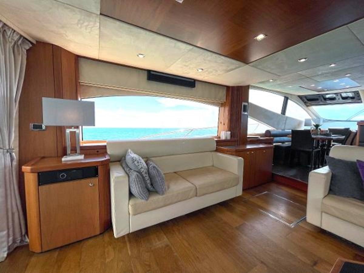 a living room with a couch and a television aboard TWINS Yacht for Sale