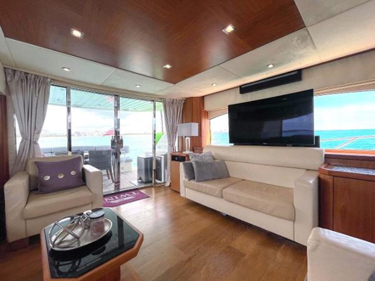 a living room with a large screen aboard TWINS Yacht for Sale