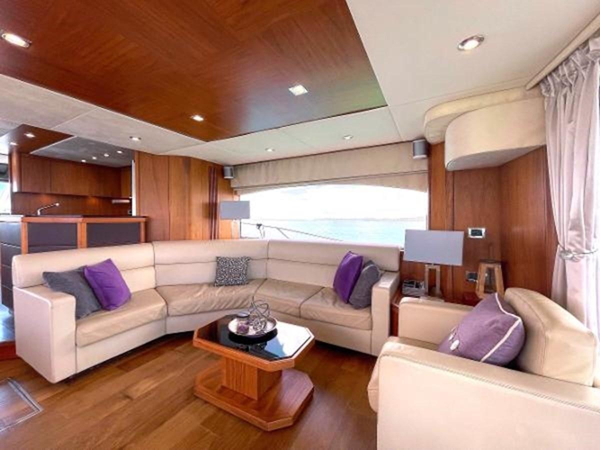 a living room with a couch and a coffee table aboard TWINS Yacht for Sale