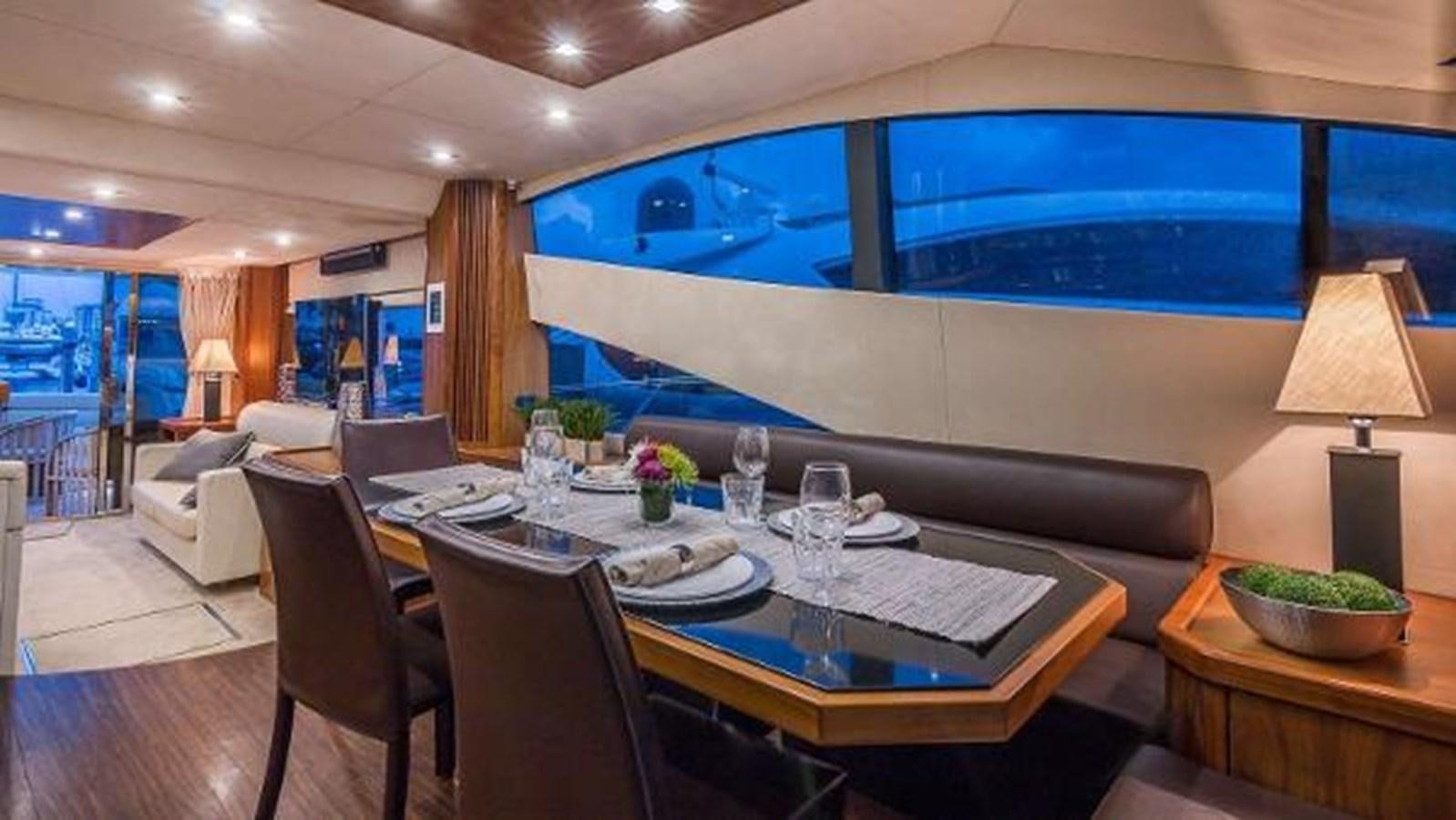a large dining table in a room aboard TWINS Yacht for Sale