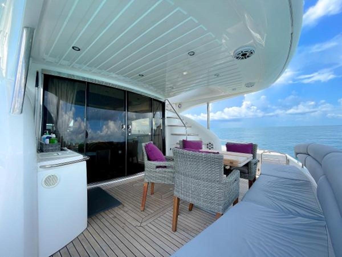 a room with a bed and a table and chairs aboard TWINS Yacht for Sale