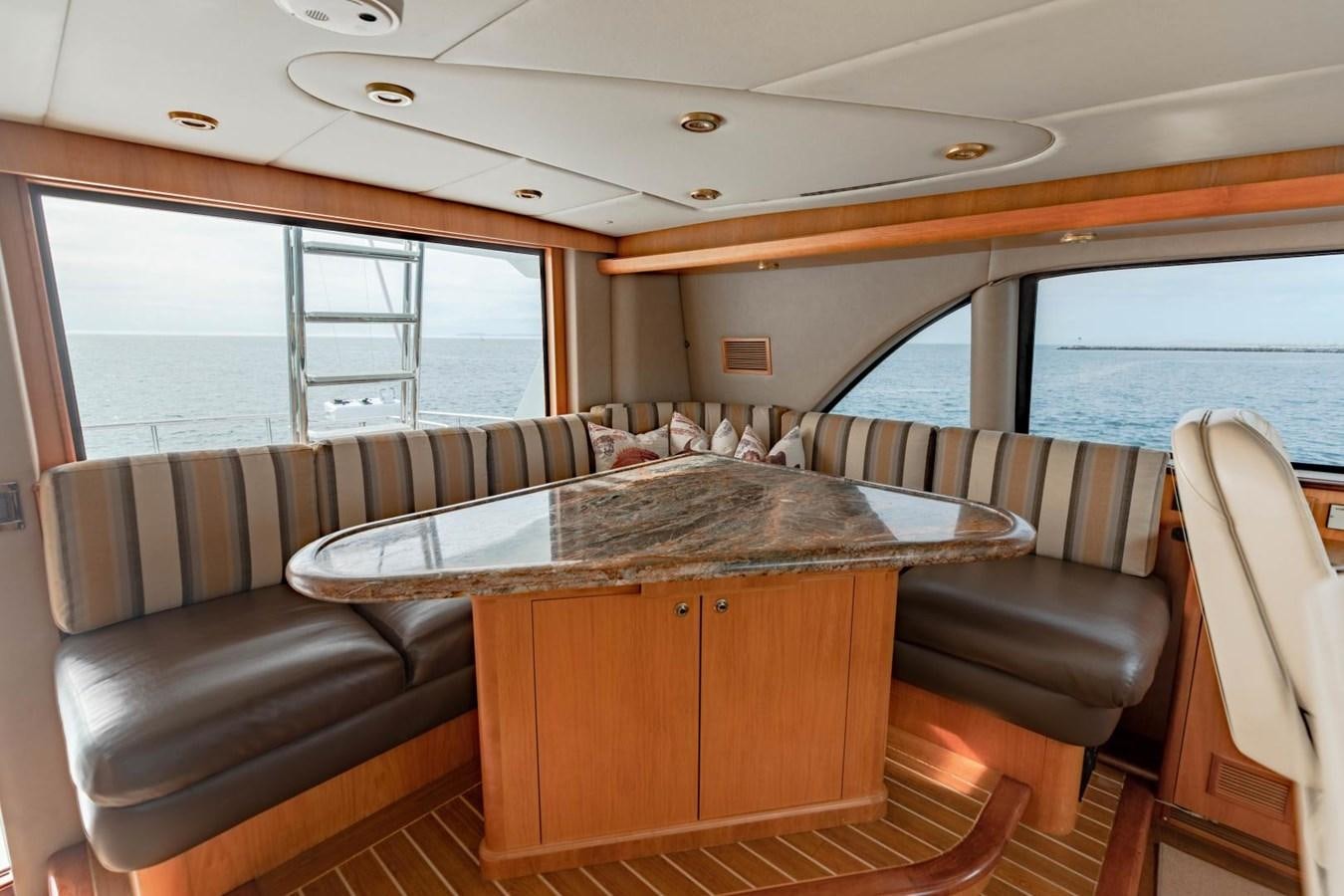 a room with a couch and a table aboard PRIME TIME Yacht for Sale