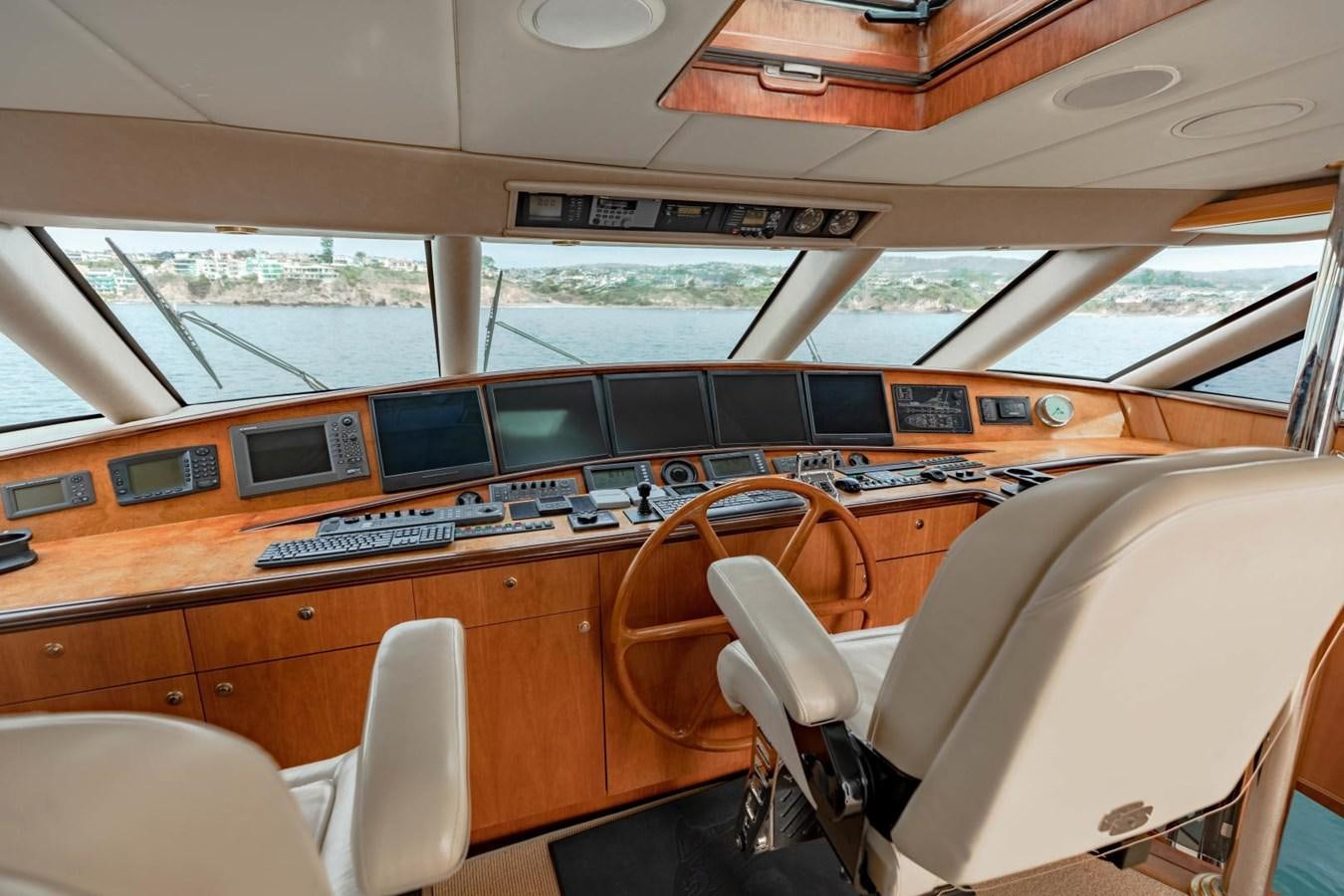 inside of a vehicle with a large window and a view of the water aboard PRIME TIME Yacht for Sale