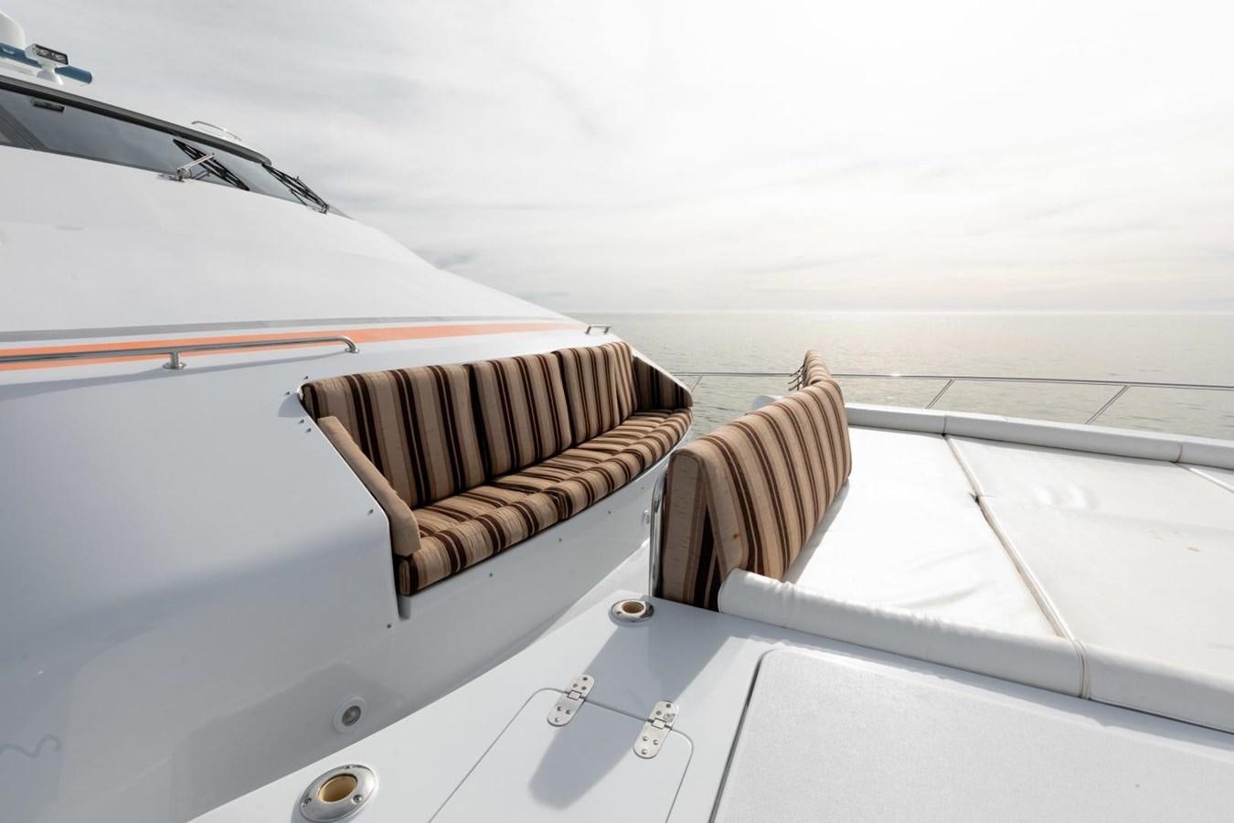 a boat with a striped cloth on the front aboard PRIME TIME Yacht for Sale