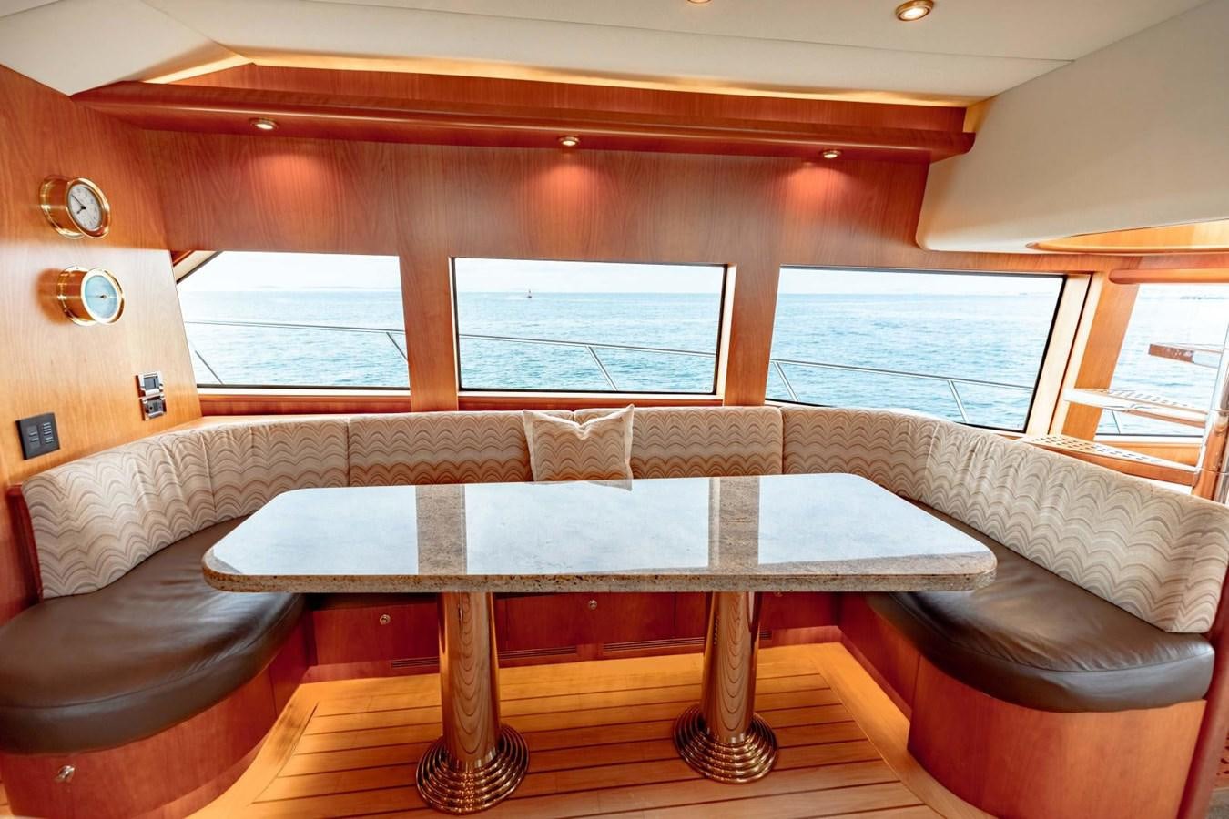 a table and couch in a room aboard PRIME TIME Yacht for Sale