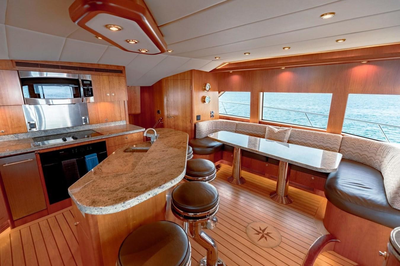 a kitchen with wooden cabinets aboard PRIME TIME Yacht for Sale