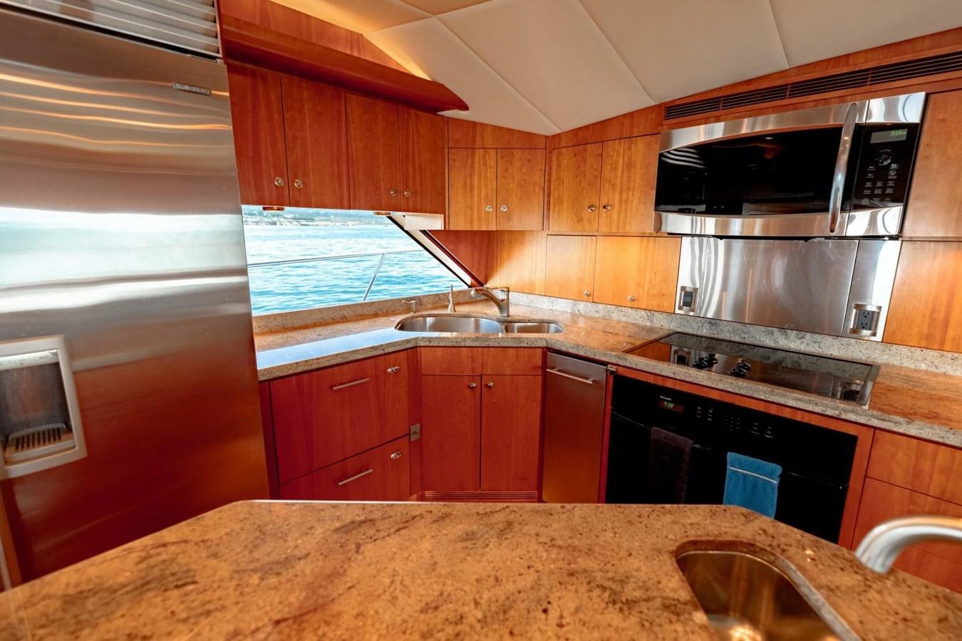a kitchen with wooden cabinets aboard PRIME TIME Yacht for Sale