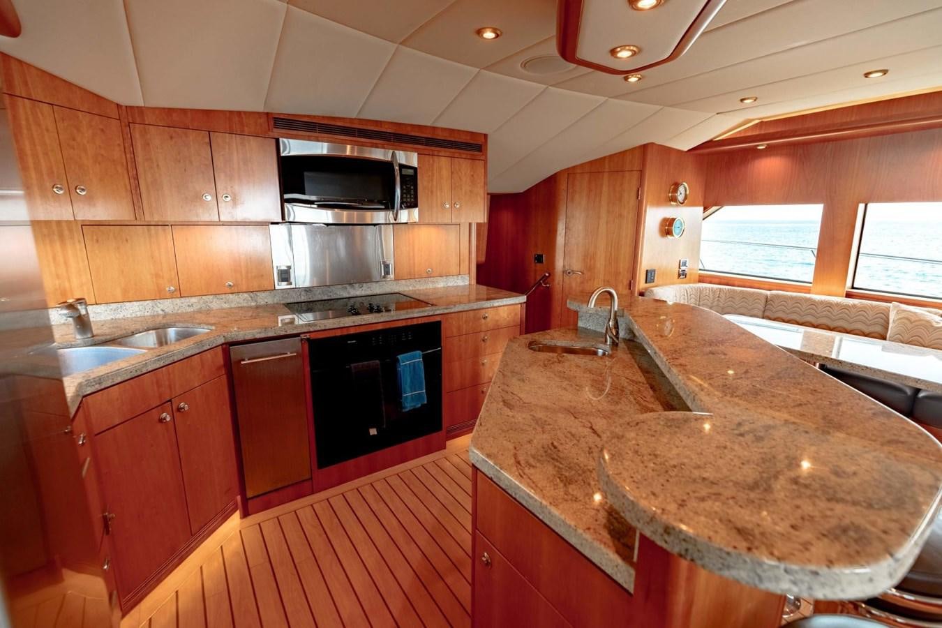 a kitchen with wooden cabinets aboard PRIME TIME Yacht for Sale