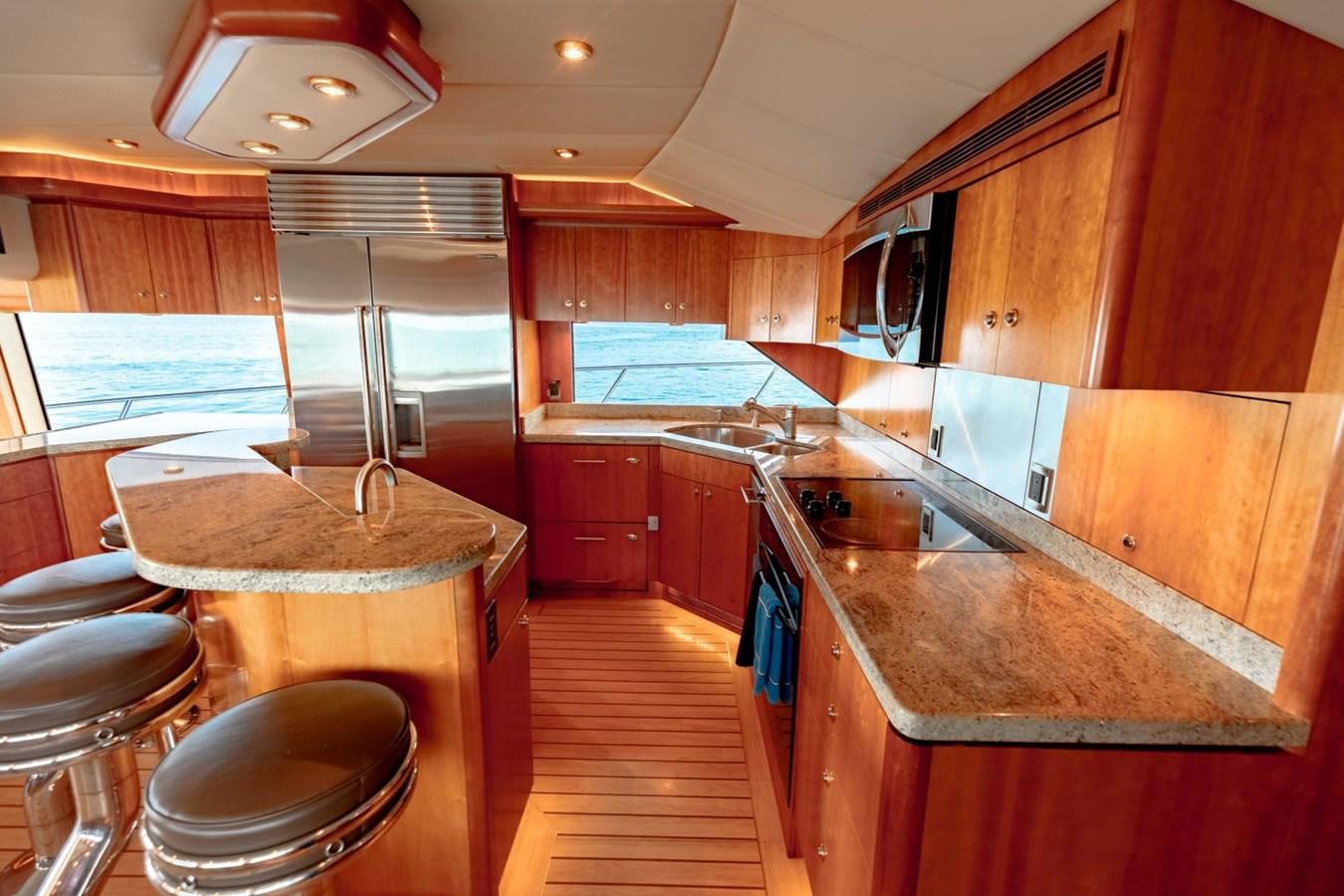 a kitchen with wooden cabinets aboard PRIME TIME Yacht for Sale