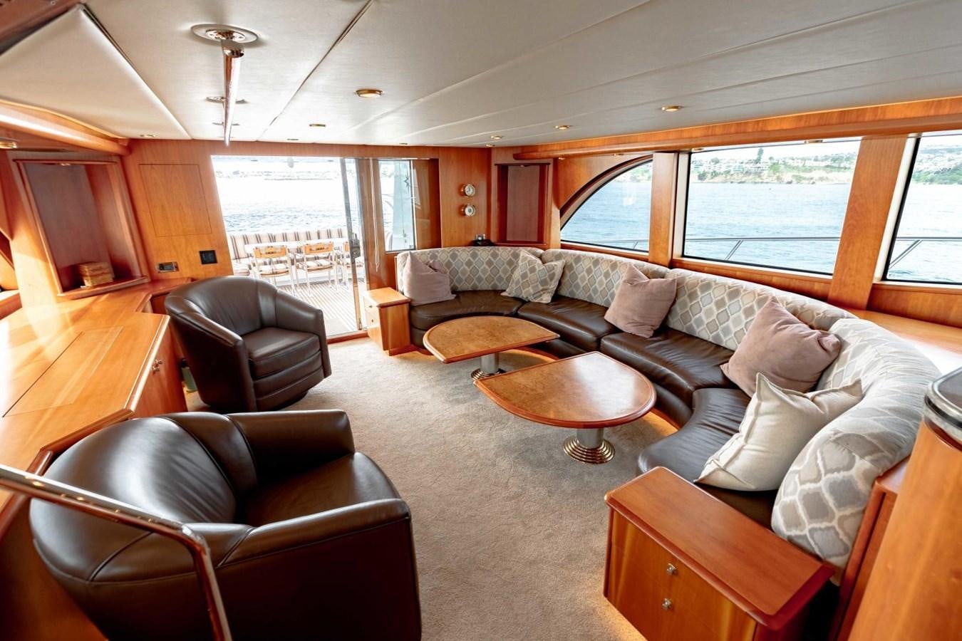 a living room with a leather couch aboard PRIME TIME Yacht for Sale