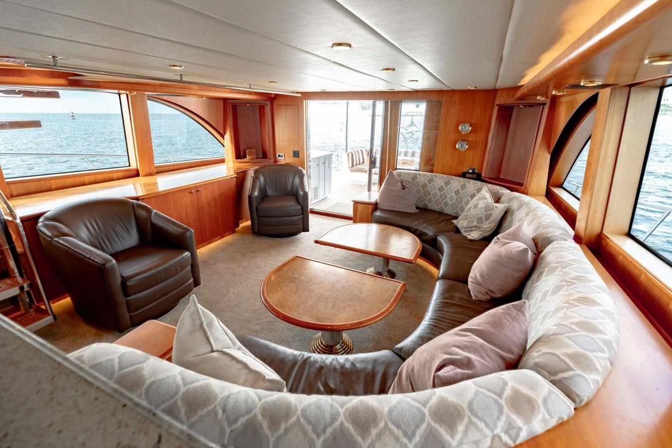 a living room with a couch and a coffee table aboard PRIME TIME Yacht for Sale