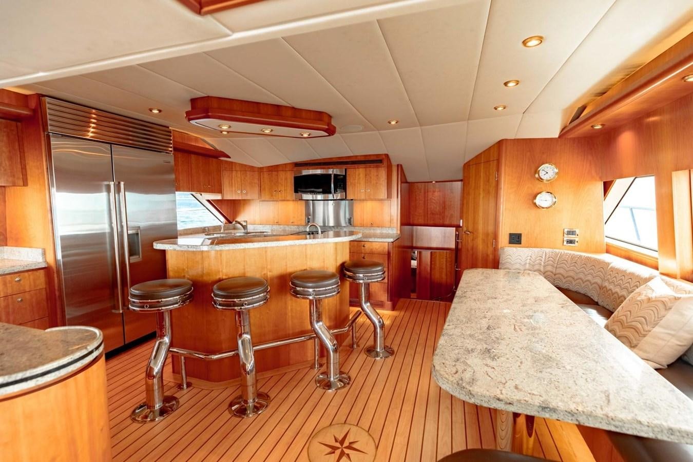 a kitchen with a large refrigerator aboard PRIME TIME Yacht for Sale