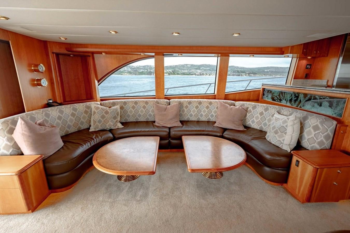 a living room with a couch and a table aboard PRIME TIME Yacht for Sale