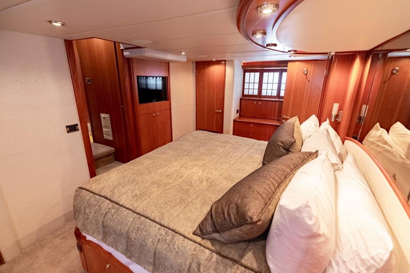 a bed with a couch aboard PRIME TIME Yacht for Sale
