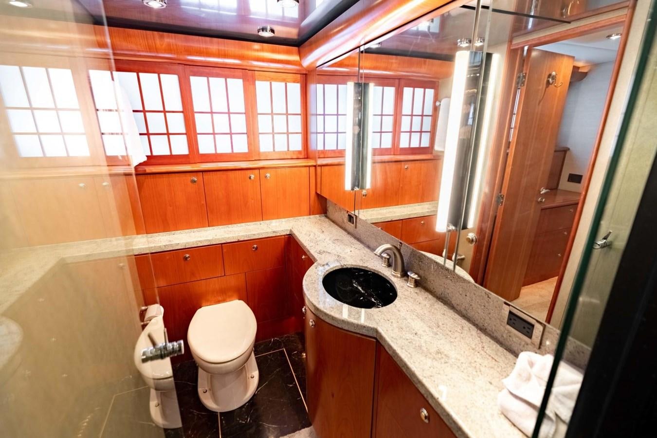 a bathroom with a sink toilet and a mirror aboard PRIME TIME Yacht for Sale