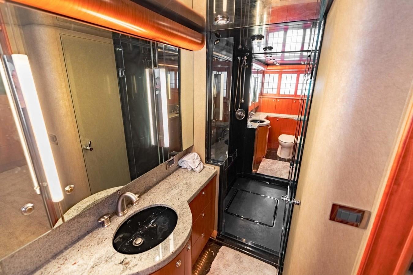 a bathroom with a sink and a large mirror aboard PRIME TIME Yacht for Sale