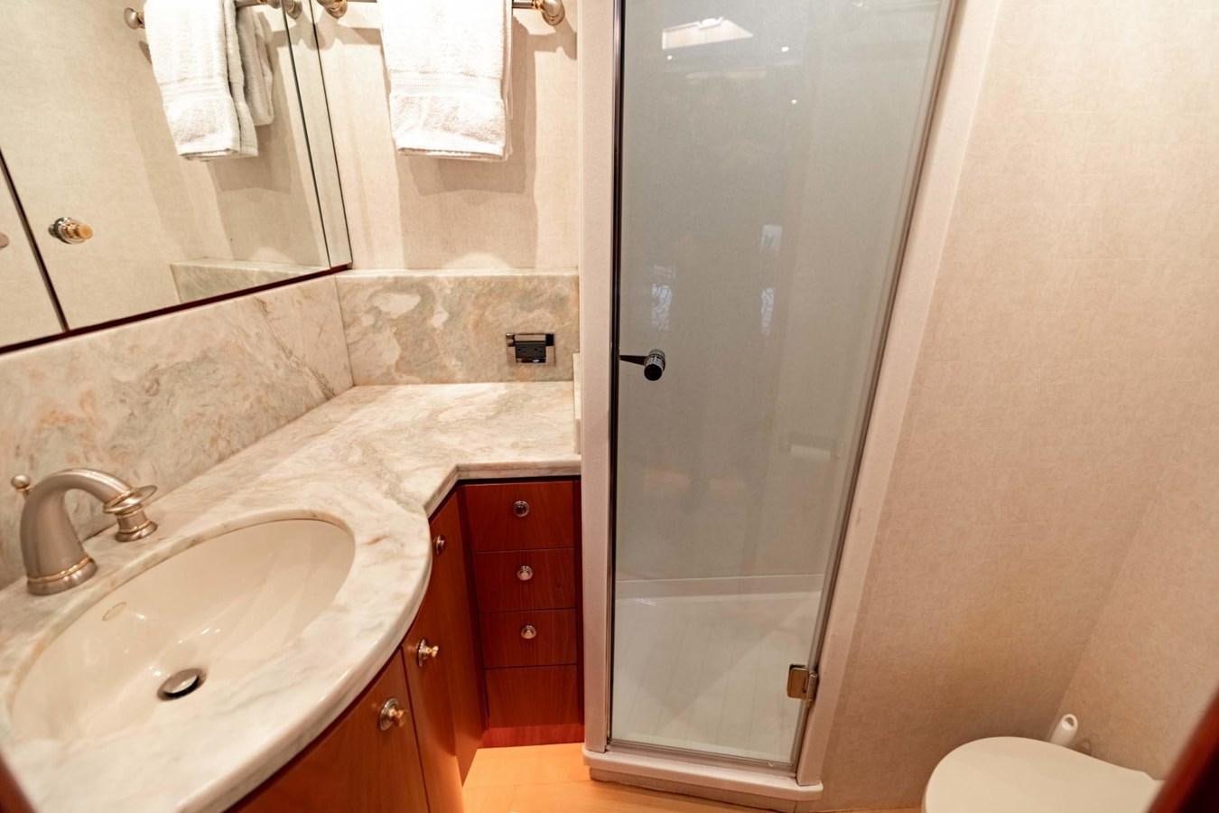 a bathroom with a sink and a shower aboard PRIME TIME Yacht for Sale