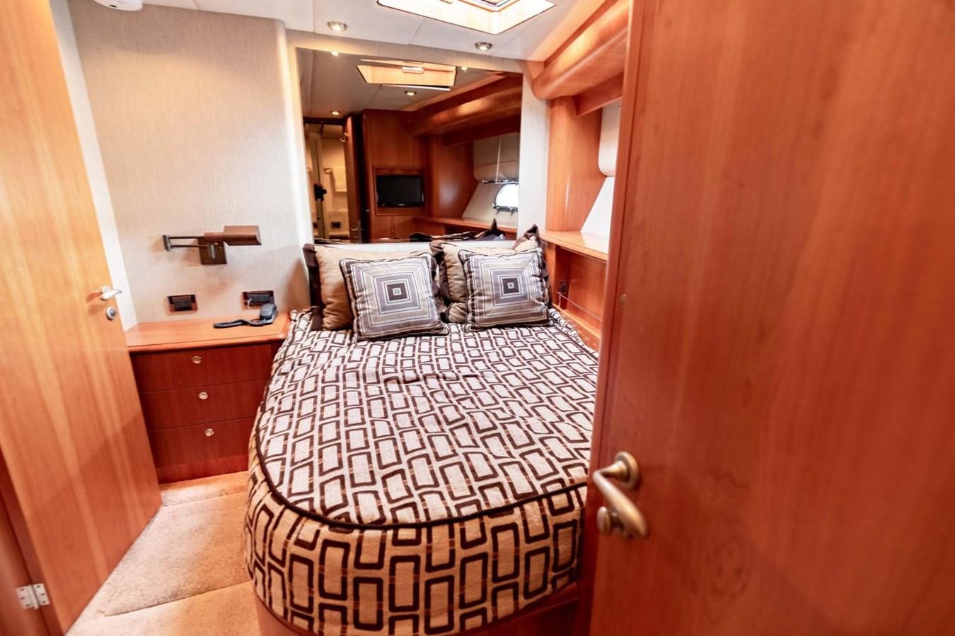 a room with a bed and a couch aboard PRIME TIME Yacht for Sale