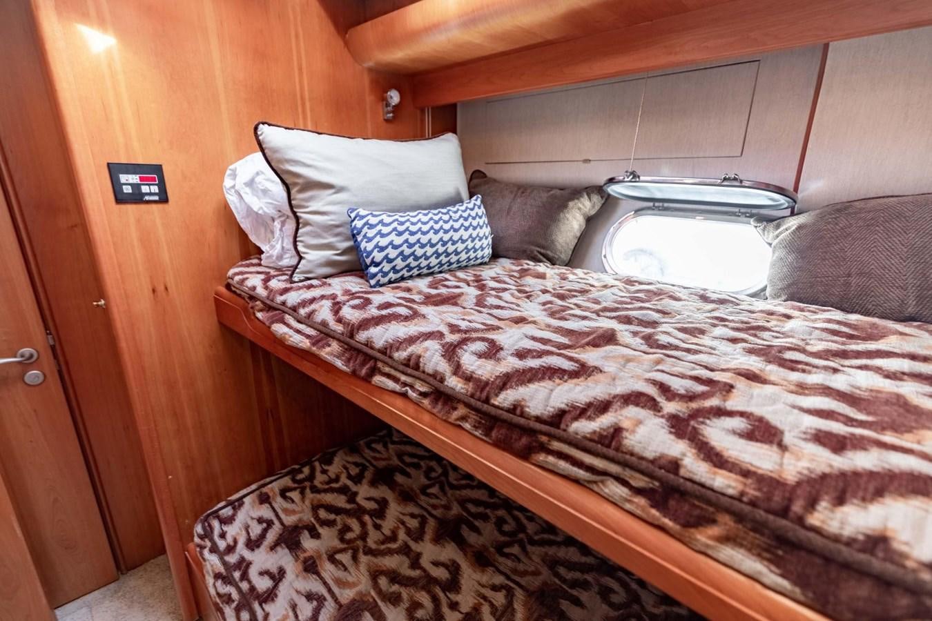 a bed with pillows aboard PRIME TIME Yacht for Sale
