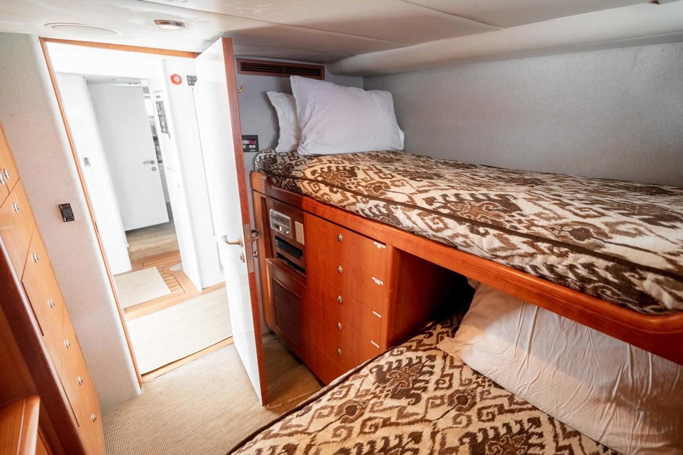 a bedroom with a bed aboard PRIME TIME Yacht for Sale