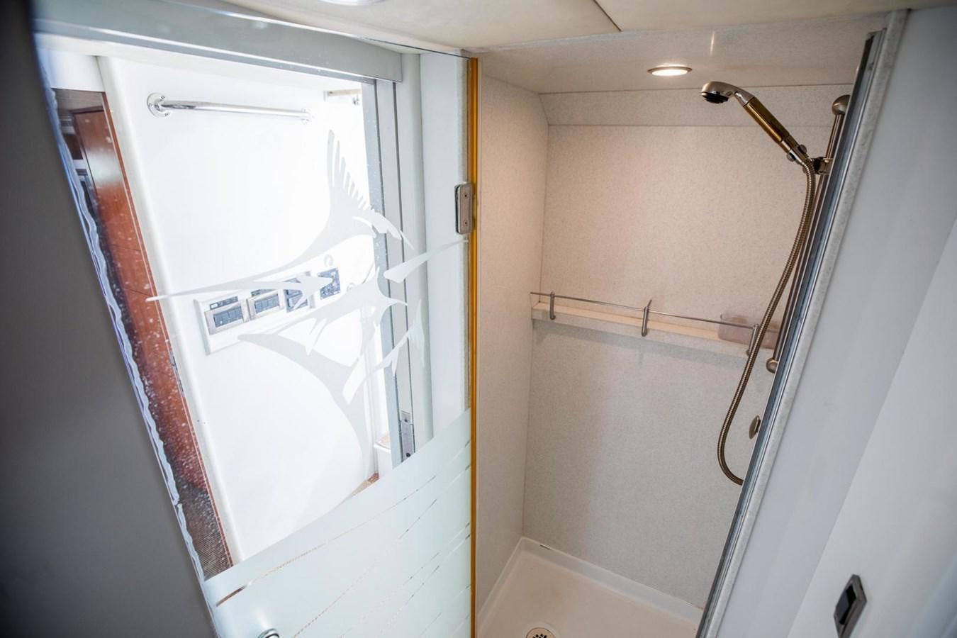 a shower unit with a shower curtain aboard PRIME TIME Yacht for Sale