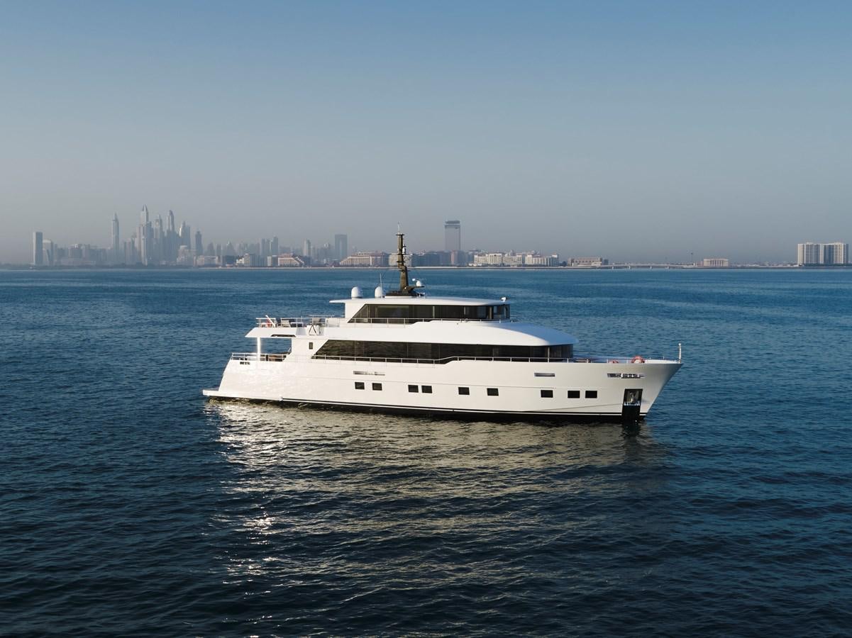a white yacht in the water aboard NOMAD 95 SUV Yacht for Sale