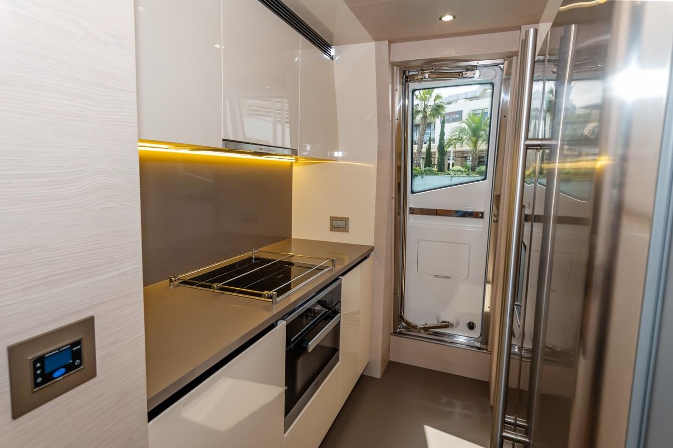 a kitchen with a glass door aboard ALINA Yacht for Sale