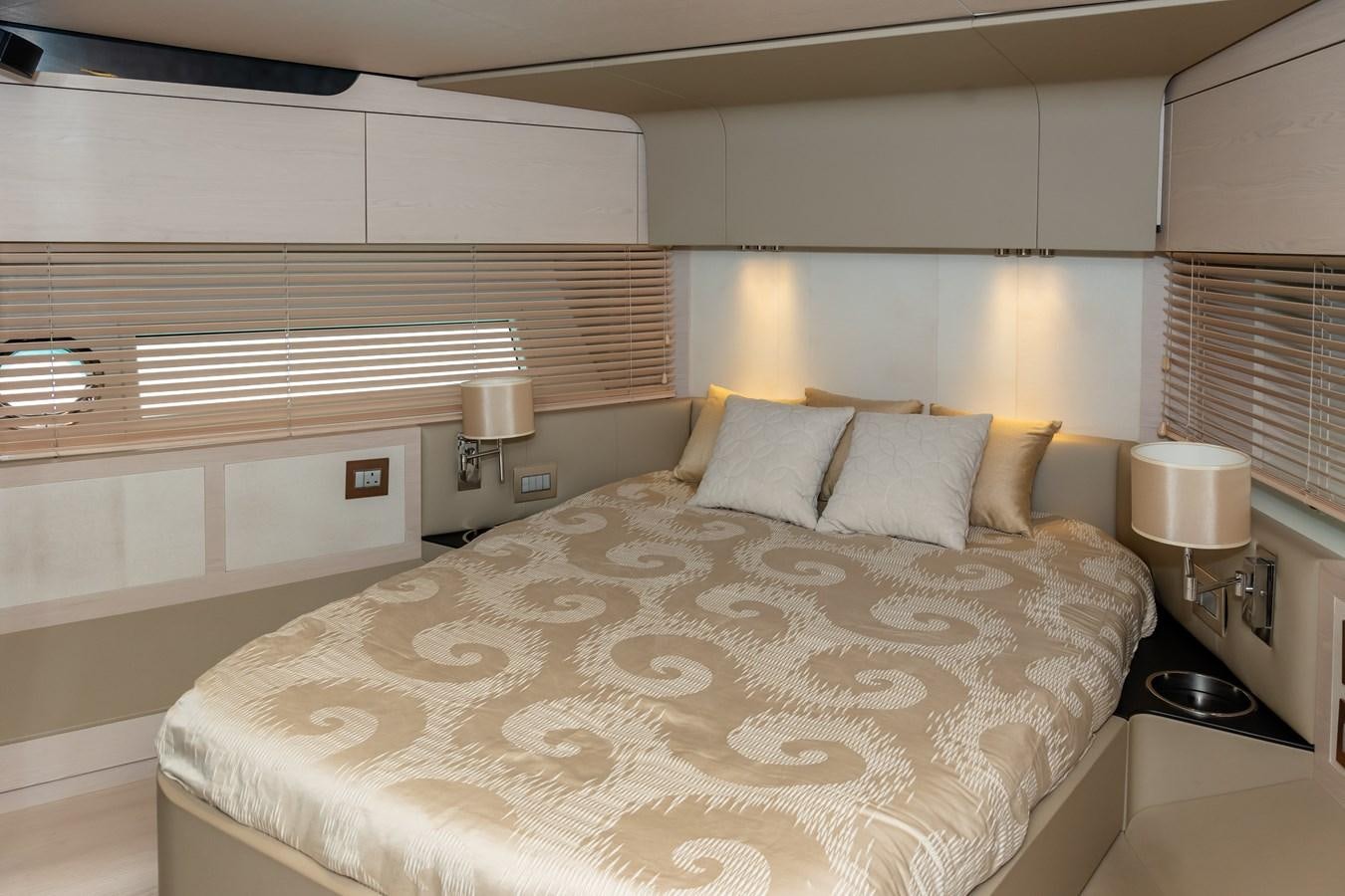a bed with a white comforter aboard ALINA Yacht for Sale