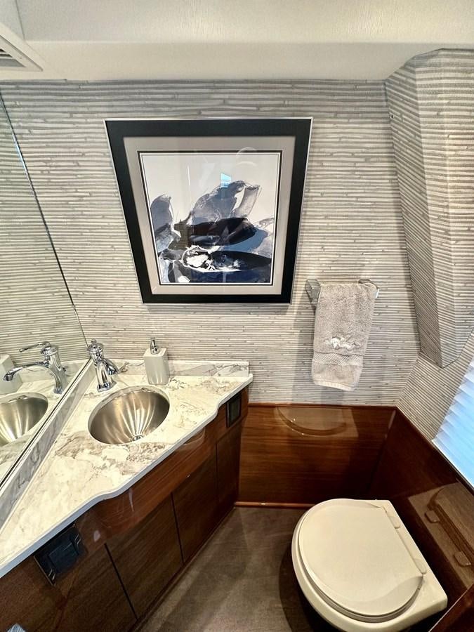 a bathroom with a painting on the wall aboard FREAK SHOW Yacht for Sale