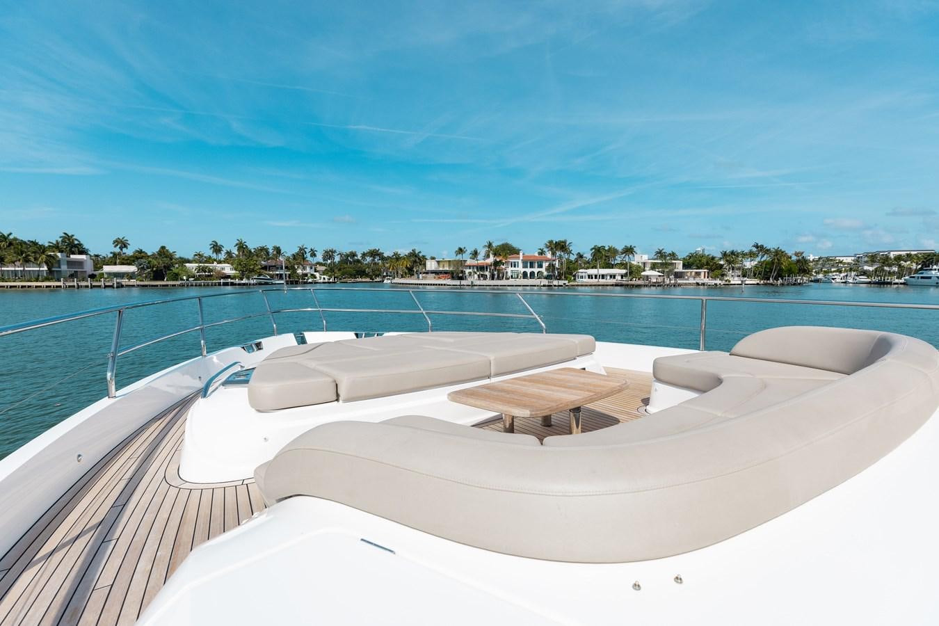 a pool with a deck and a view of a city aboard DROPLET Yacht for Sale
