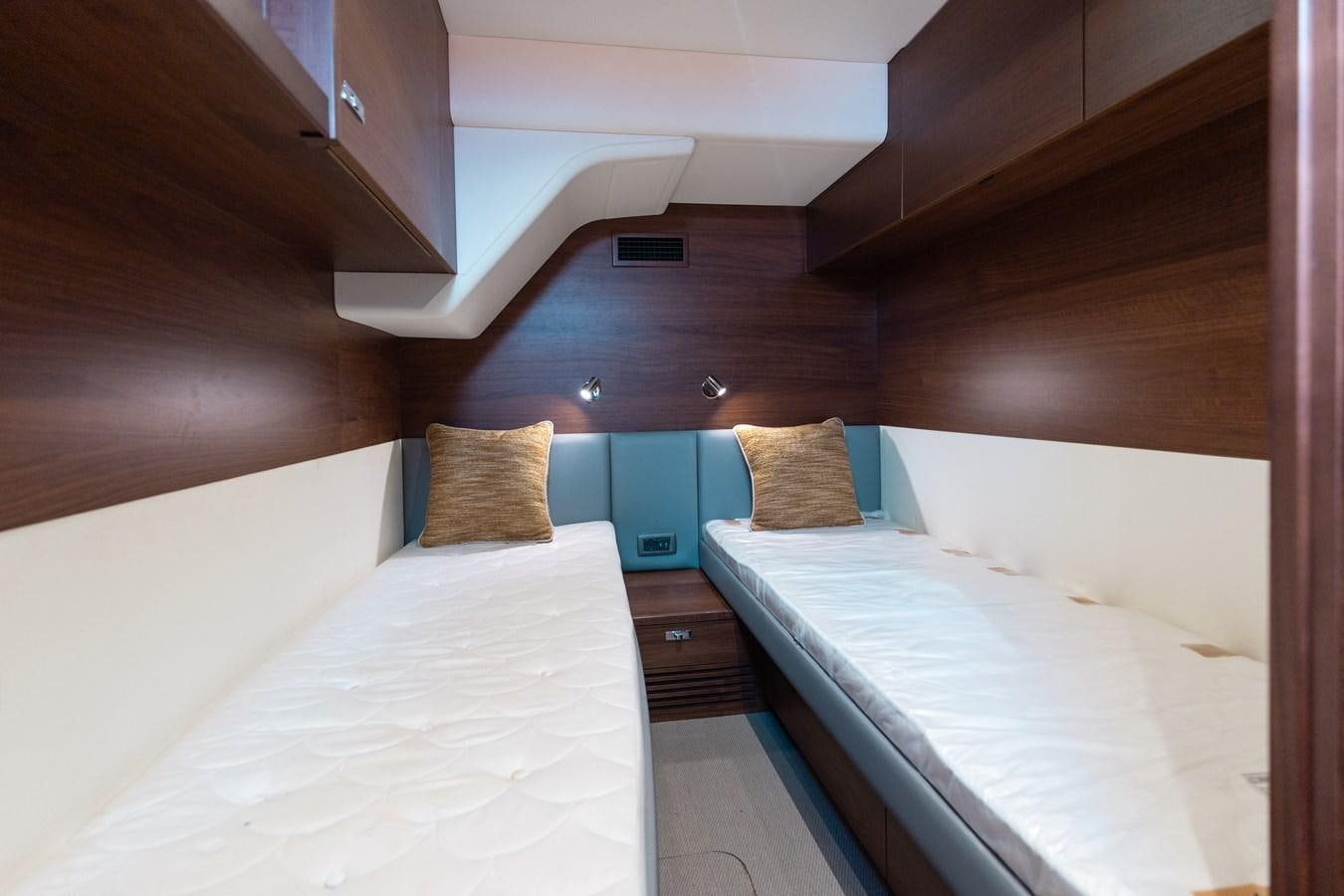 a room with two beds aboard DROPLET Yacht for Sale