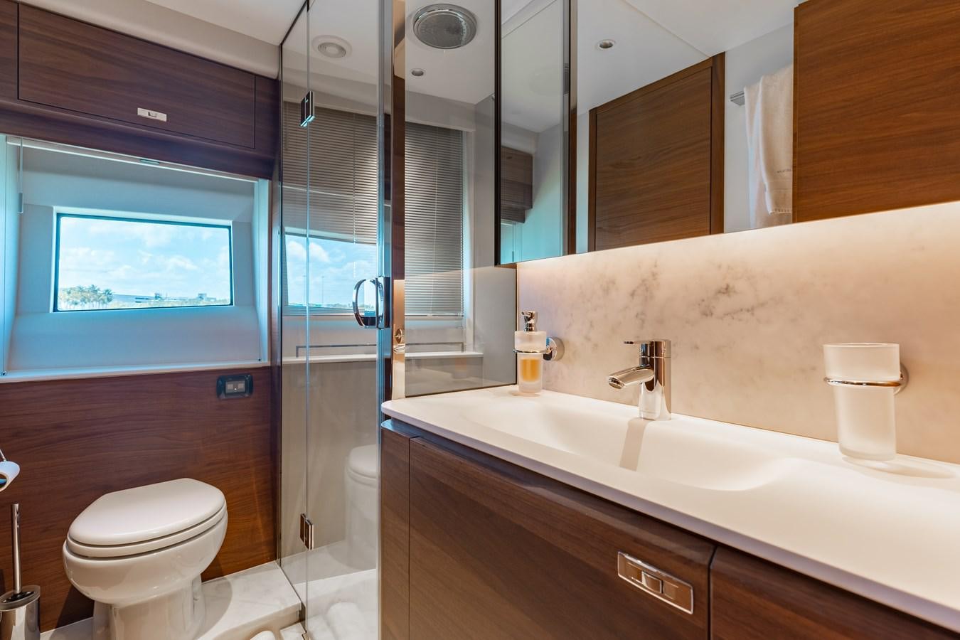 a bathroom with a glass shower aboard DROPLET Yacht for Sale