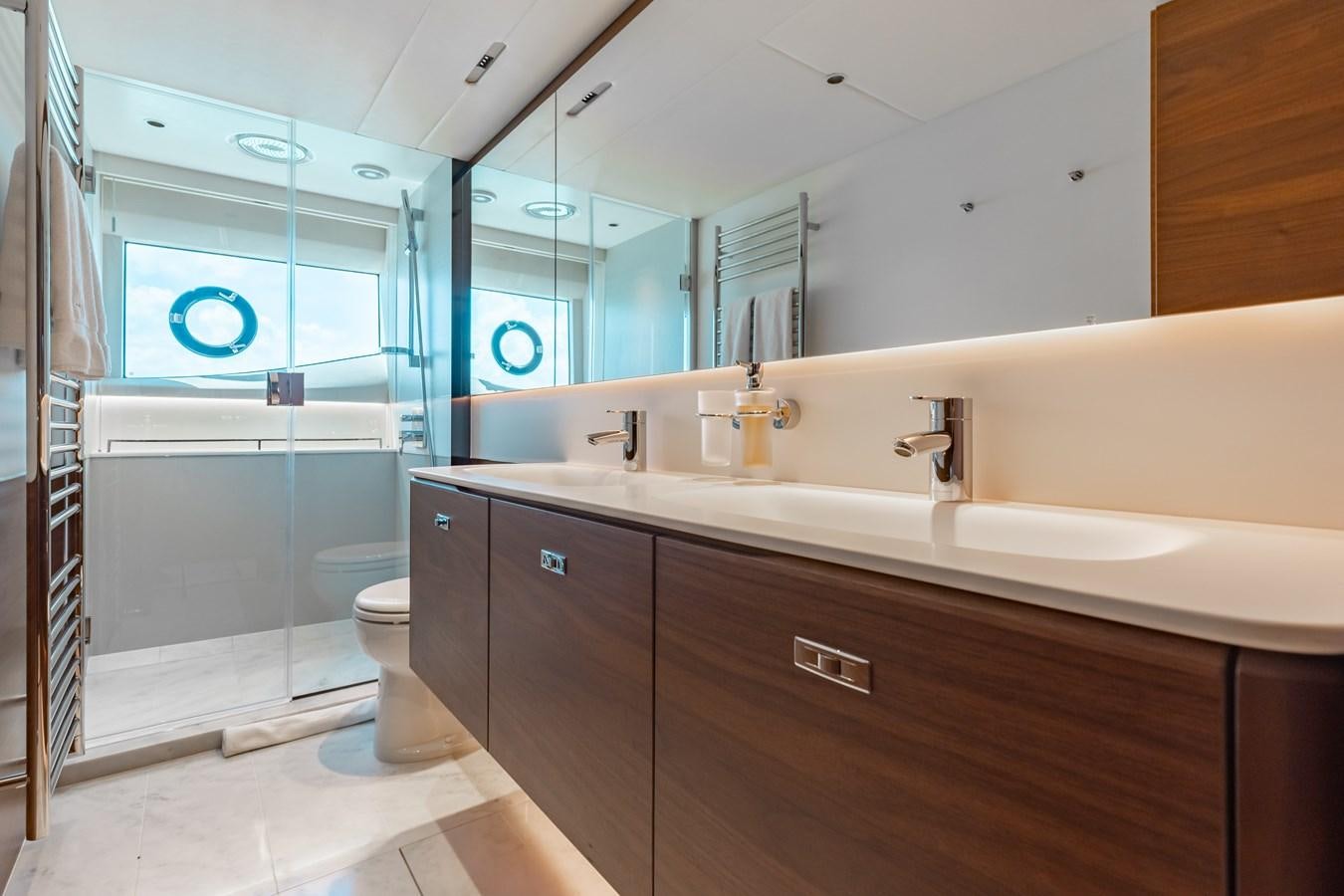 a bathroom with a large mirror aboard DROPLET Yacht for Sale