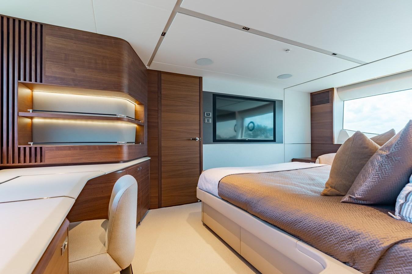 a room with a bed and a desk aboard DROPLET Yacht for Sale