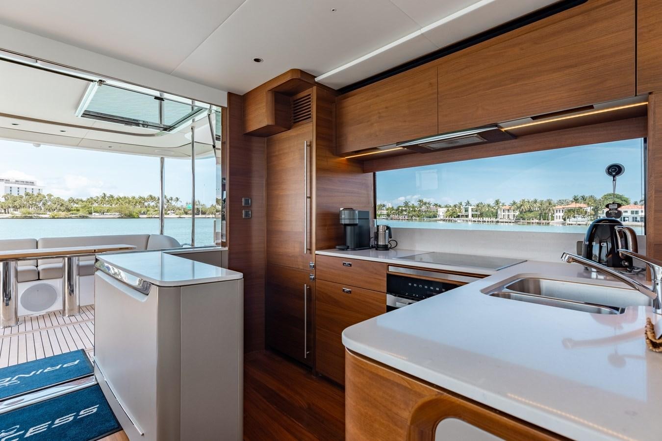 a kitchen with a sink and a refrigerator aboard DROPLET Yacht for Sale