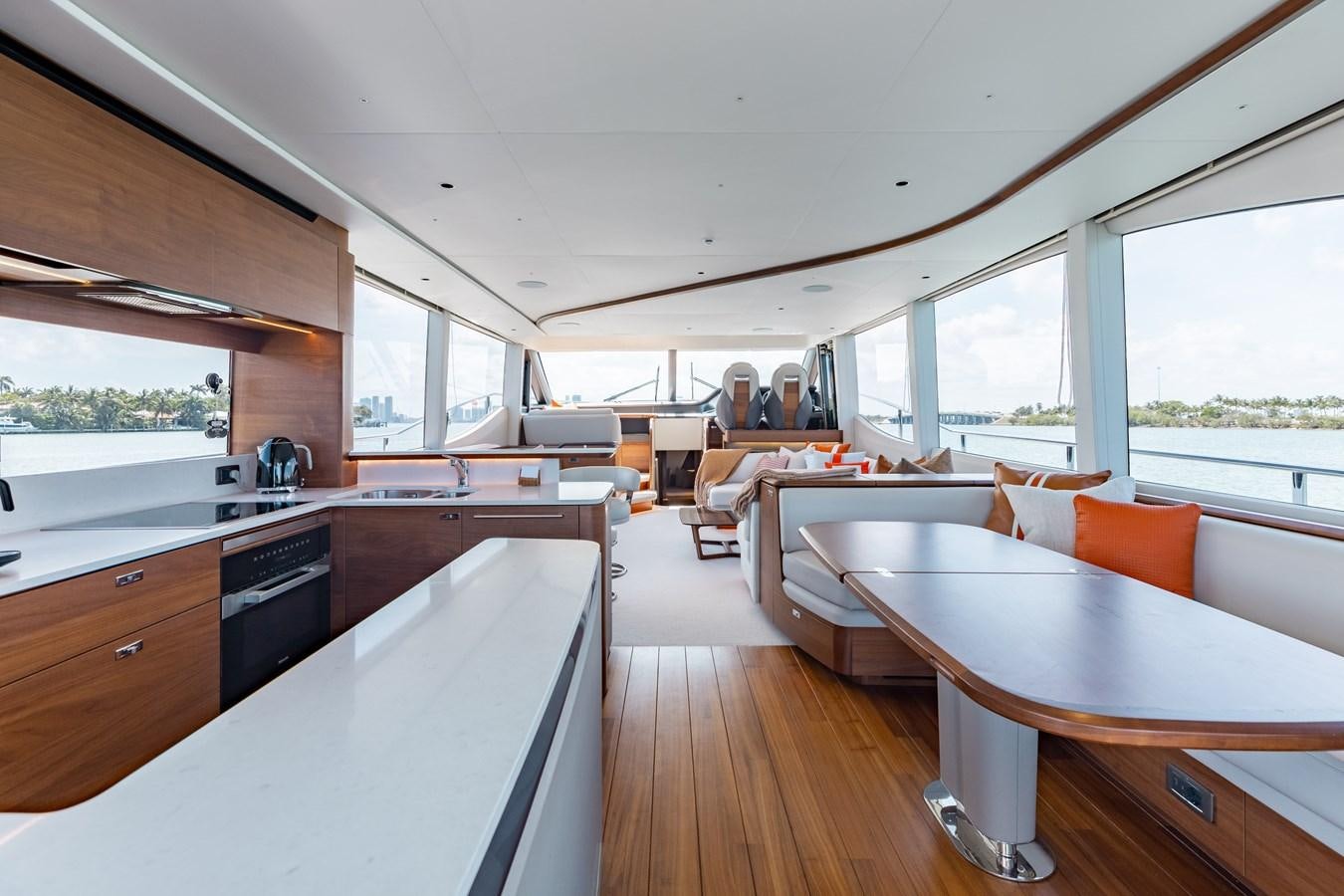 a large open kitchen and dining area aboard DROPLET Yacht for Sale
