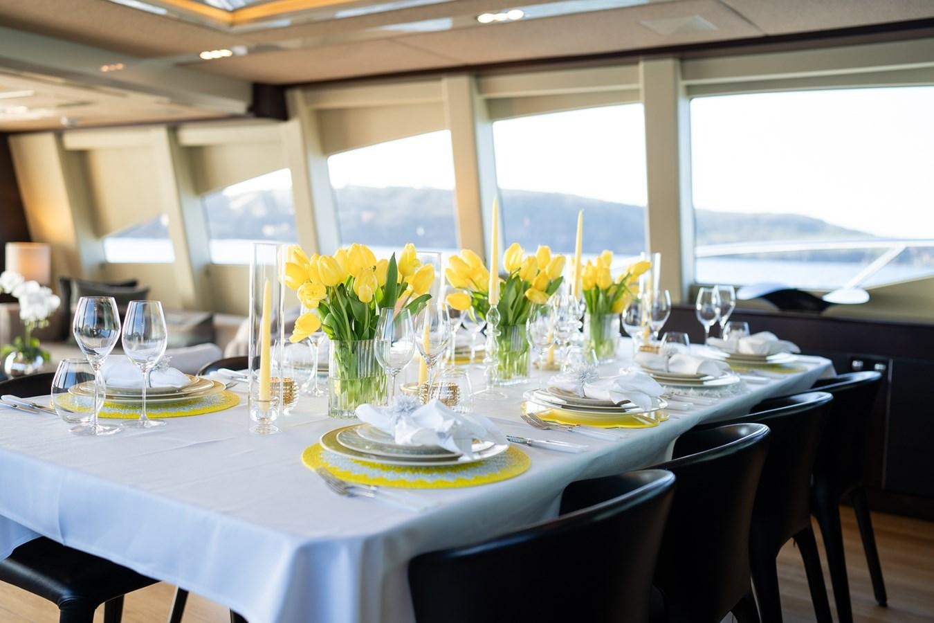 a table set for a formal dinner aboard QUANTUM Yacht for Sale