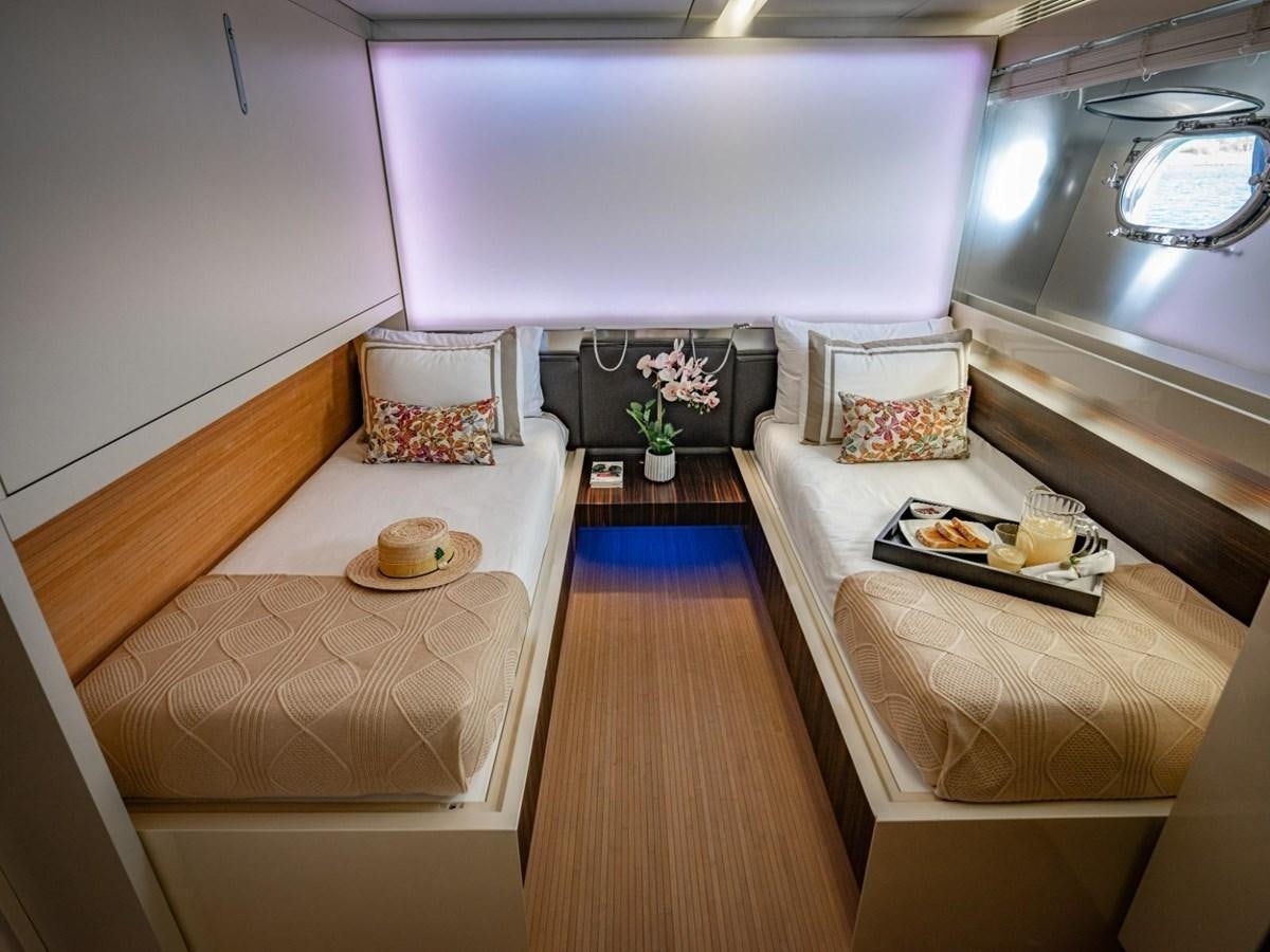 a room with a bed and a table aboard CANADOS FLYBRIDGE FAST Yacht for Sale