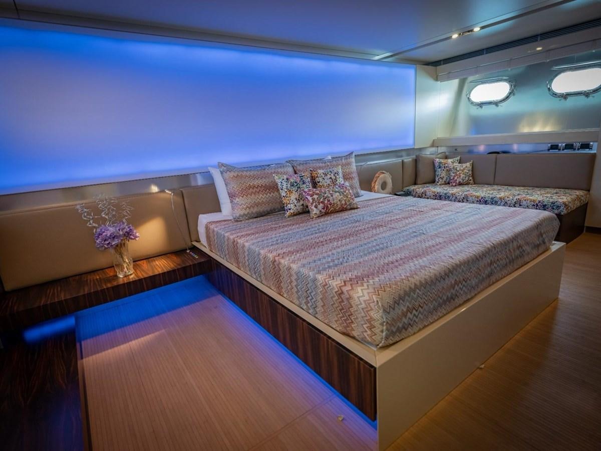 a room with a bed and a couch aboard CANADOS FLYBRIDGE FAST Yacht for Sale
