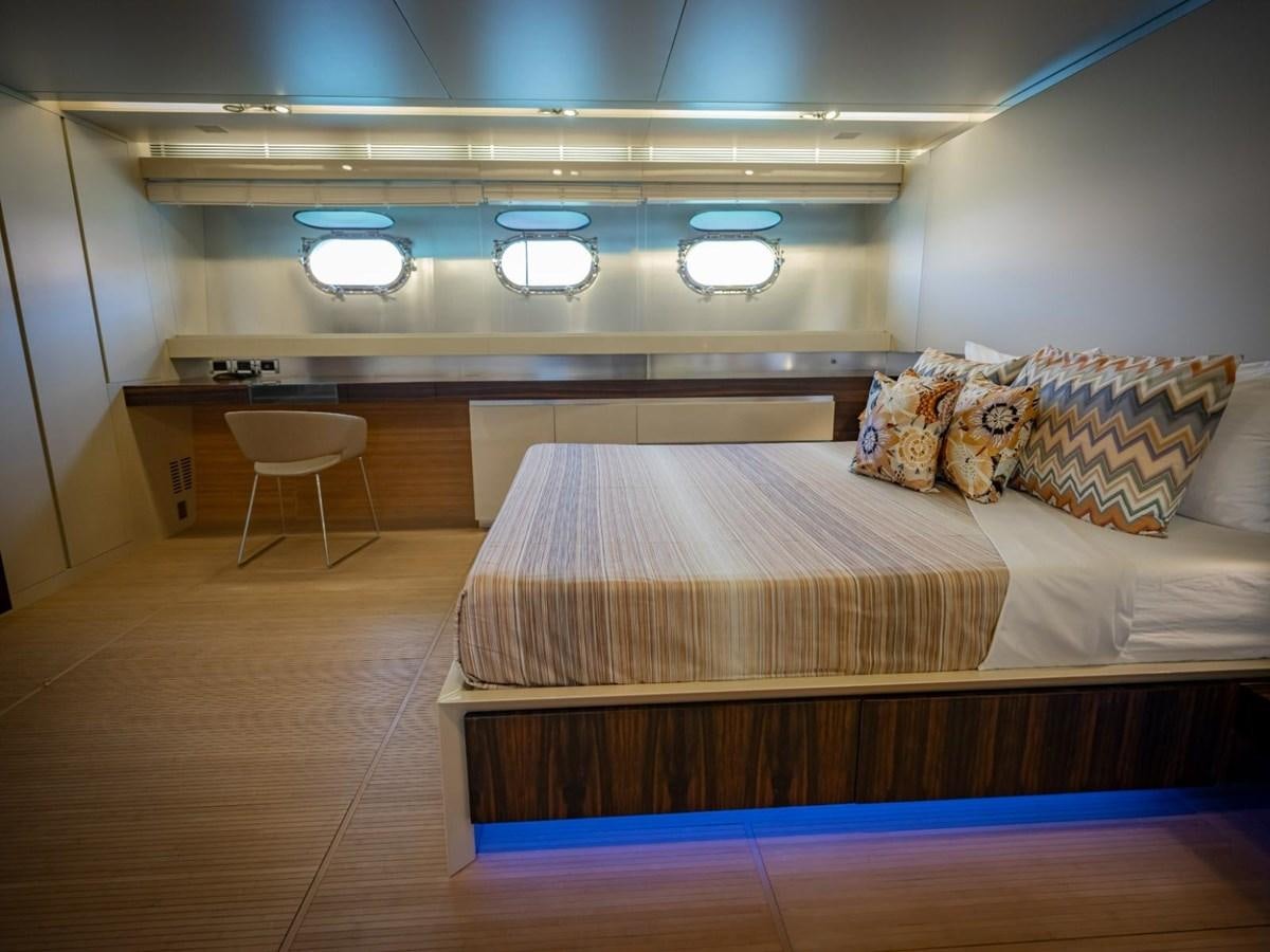 a room with a bed and a chair aboard CANADOS FLYBRIDGE FAST Yacht for Sale