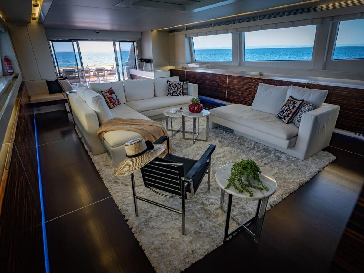 a living room with a couch and a table aboard CANADOS FLYBRIDGE FAST Yacht for Sale