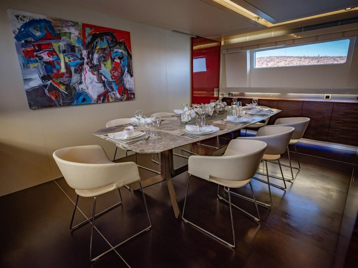 a room with a table and chairs aboard CANADOS FLYBRIDGE FAST Yacht for Sale