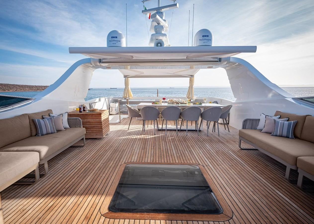 a deck with a laptop and a table on it aboard CANADOS FLYBRIDGE FAST Yacht for Sale