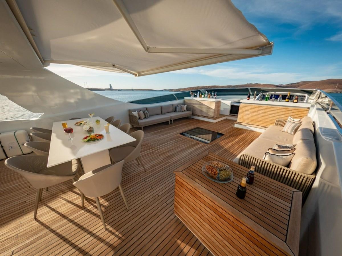 a large white tent with a table and chairs on a deck aboard CANADOS FLYBRIDGE FAST Yacht for Sale