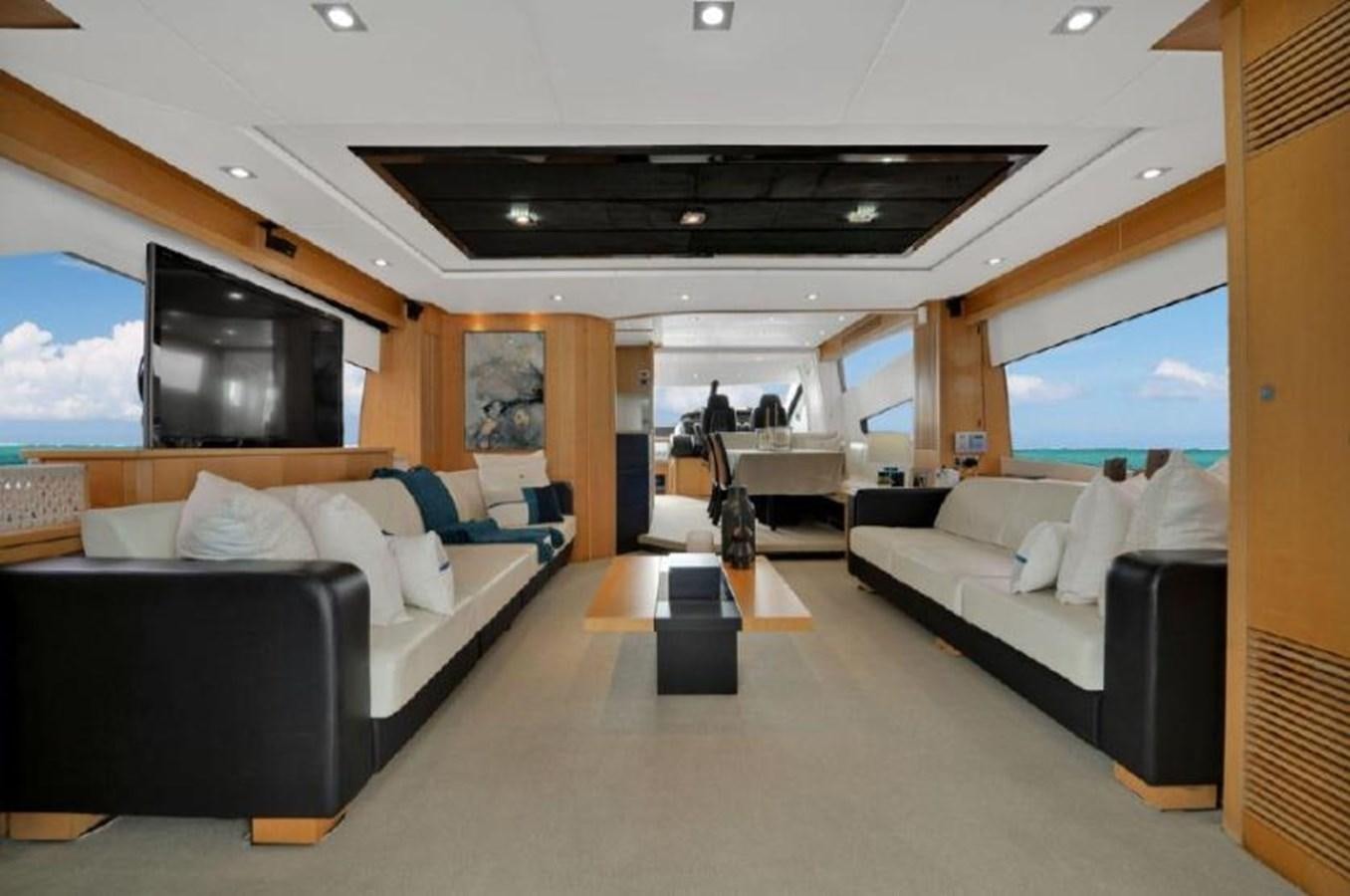 a living room with a large couch and a tv aboard SUNSEEKER 88  Yacht for Sale