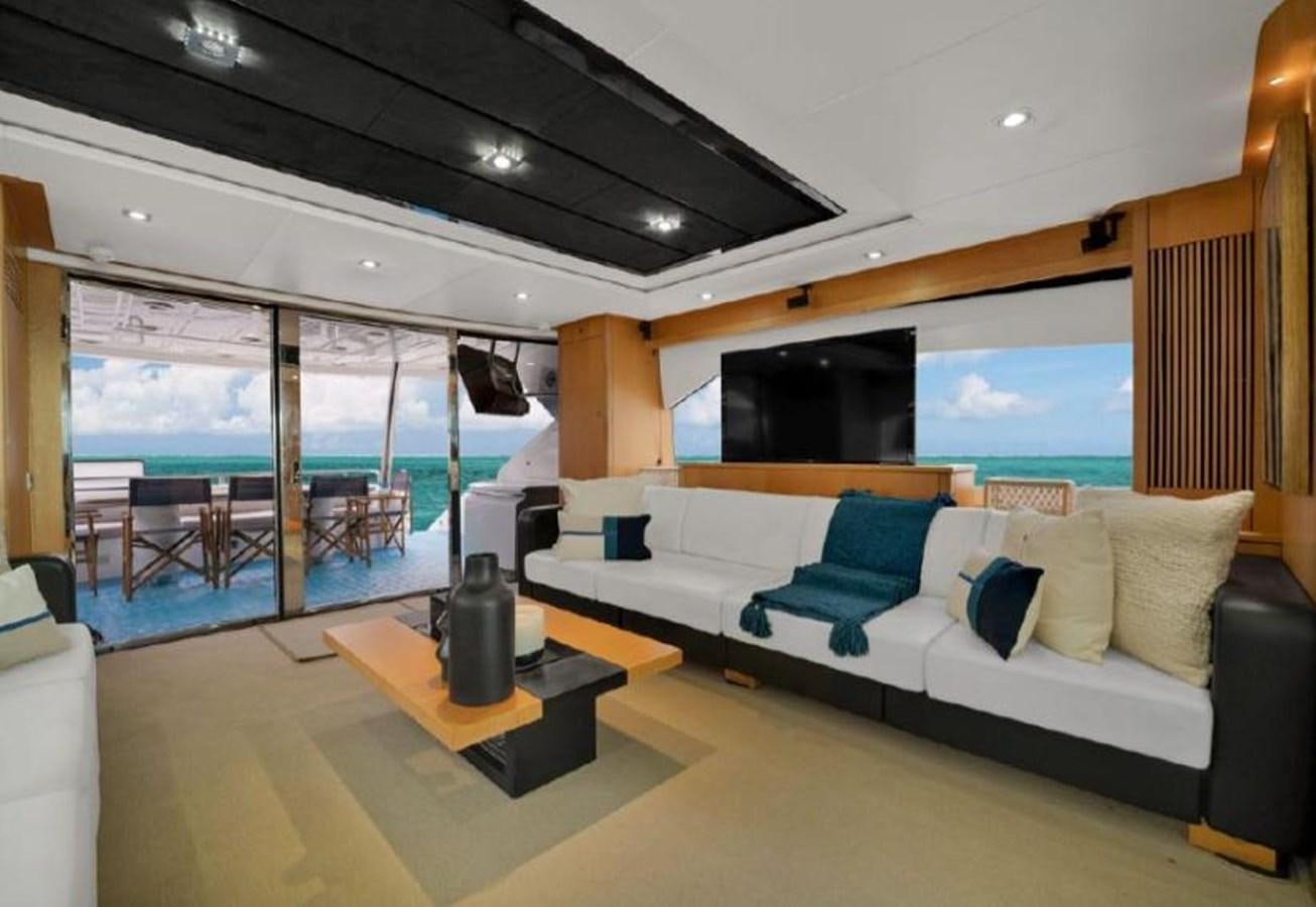 a living room with a large window aboard SUNSEEKER 88  Yacht for Sale